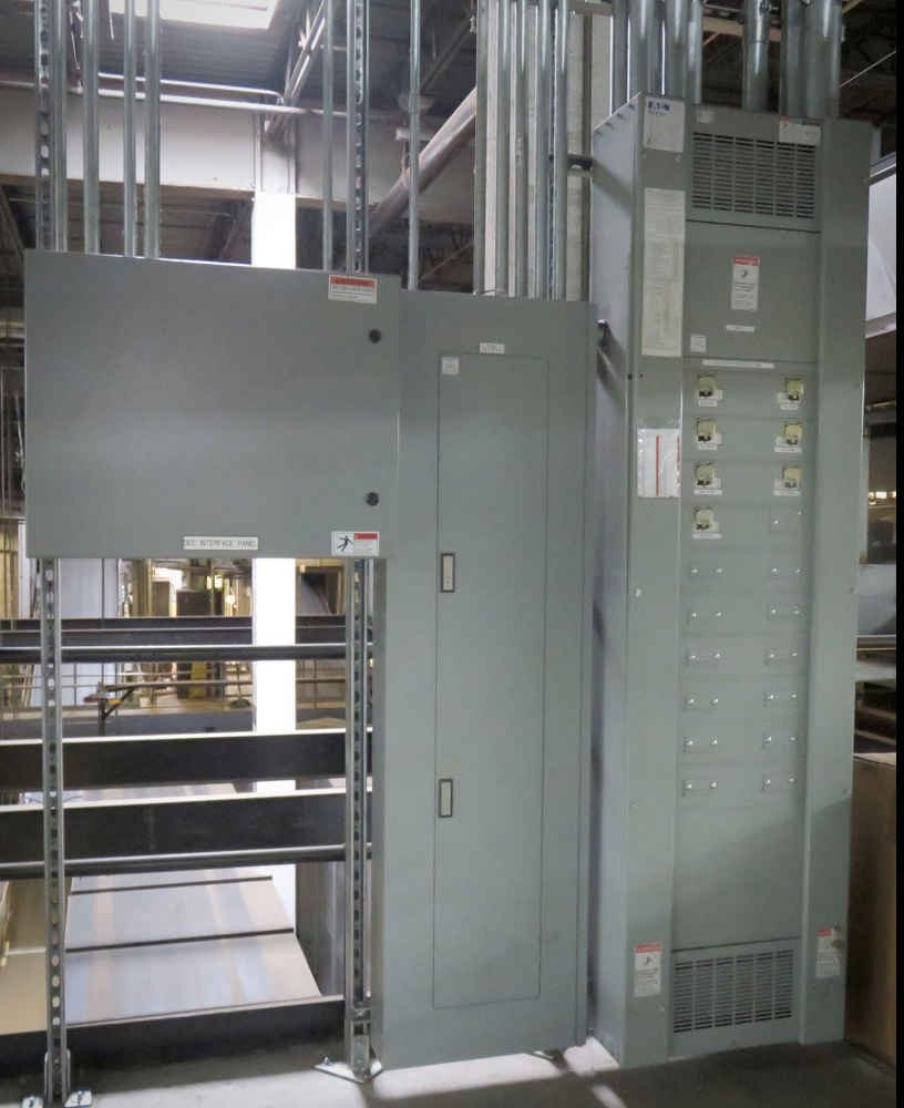 Photo of an electrical panel and breaker box in an industrial setting